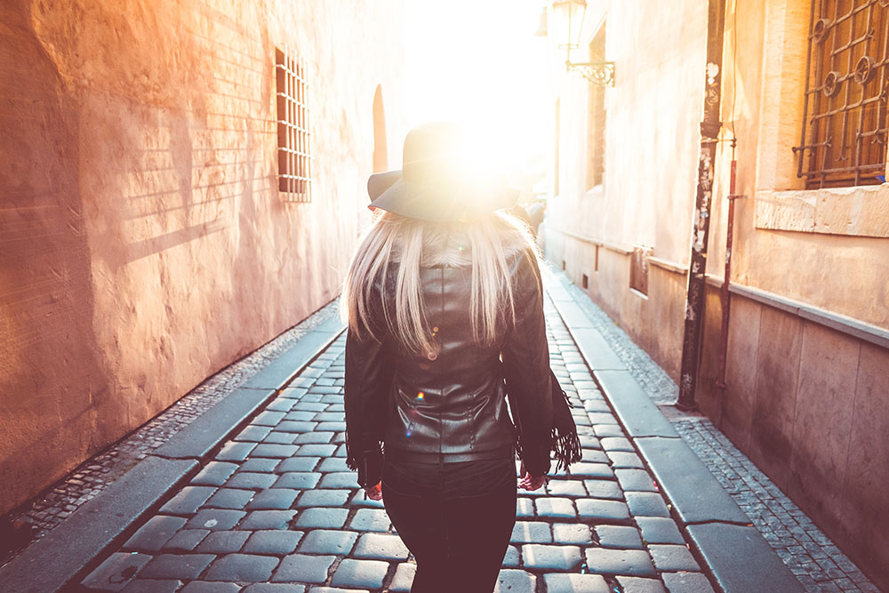 young-woman-walking-alone-in-prague-streets-picjumbo-com
